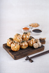 Takoyaki is Japanese Street Food containing with octopus, sausage or cheese. garnish with seaweed and katsuobushi