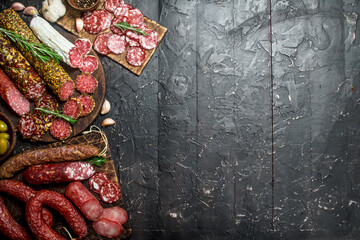 Assortment of different salami with spices and herbs.