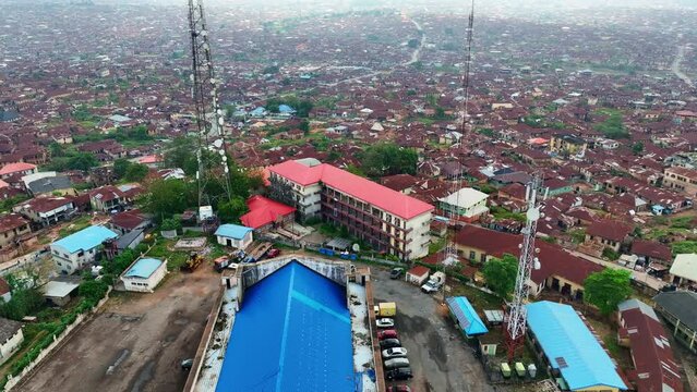 Aerial - Forward tilt-down shot of Mapo hall and Ibadan metropolis