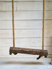 swing in white wooden background.