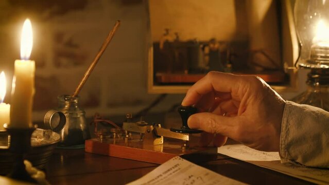 19th century telegrapher using a Morse code key to send messages
