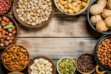 Assortment of different nuts in bowls.