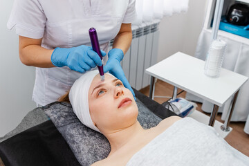 Cosmetologist making mesotherapy injection. Dermatologist making mesotherapy injection with dermapen on face for rejuvenation on the spa center. Beauty treatment at professional dermatology clinic.