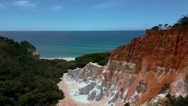 Pinnacles at Beowa and Ben Boyd National Park, New South Wales, Australia, near Sydney. Drone aerial view with seaside sandy clear water beach red rock in 4K UHD. Tourist attraction nature documentary