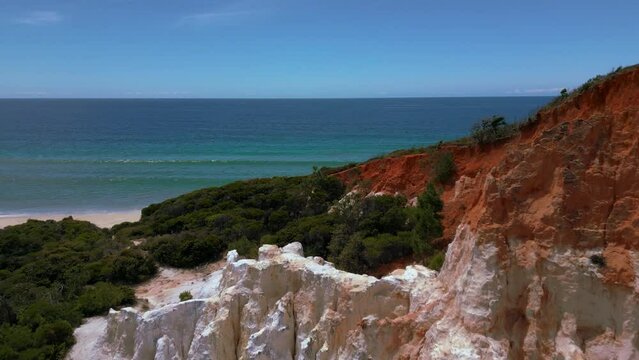 Scenic red rock Pinnacles at Beowa and Ben Boyd National Park, New South Wales, Australia, near Sydney. Drone aerial view of seaside sandy beach sea in 4K UHD. Tourist attraction nature documentary.