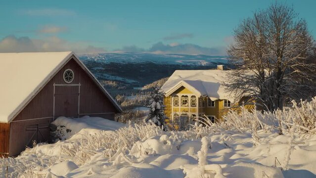 Static shot of colorful houses on mountaintop during lighting snowy day in winter - Norway, Innlandet, Valdress, Beitostolen, Beito