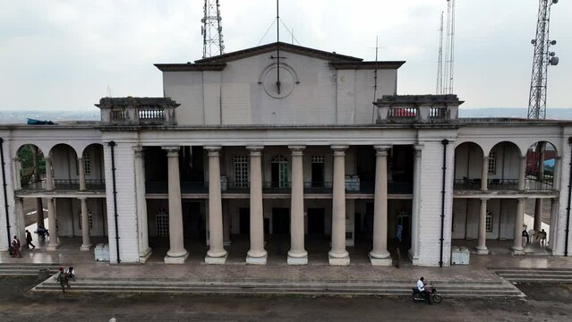 Aerial - reverse shot of colonial-style building in Africa