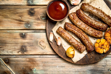 Grilled beef sausage with tomato sauce .