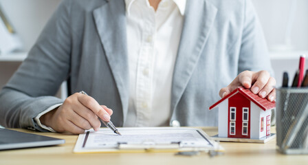 Business people signing contract making deal with real estate agent Concept for consultant home insurance.Real estate investment Property insurance security. Real estate agent offer house