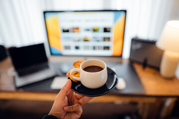 Coffee cup,hand holding a cup of coffee at the desk