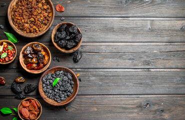 Assortment of different kinds of dried fruits in bowls.