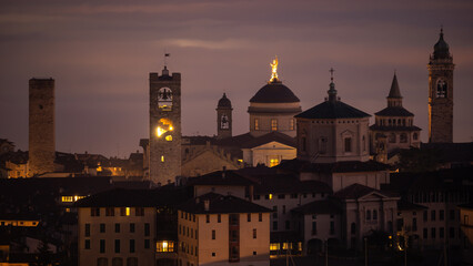 Fototapeta na wymiar Bergamo. One of the beautiful city in Italy. Landscape at the old town from the hill at evening. Amazing view of the towers, bell towers and main churches. Touristic destination. Best of Italy