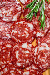 Sliced smoked salami with garlic and herbs.