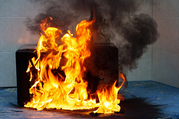 microwave oven on fire. the concept of fire in the kitchen and malfunctions, breakdowns of...