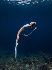 Professional freediver fun underwater in blue ocean - obrazy, fototapety, plakaty