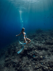 Freediver girl enjoy underwater in tropical blue ocean