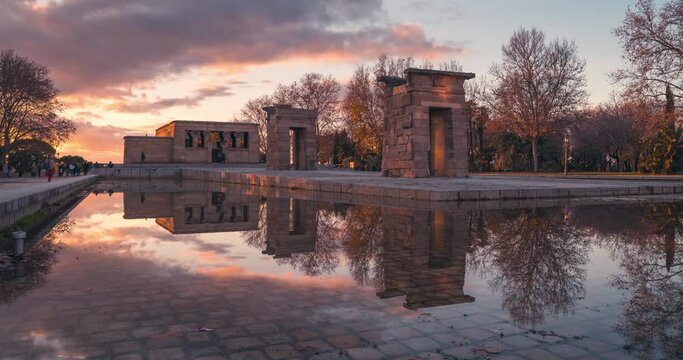 Templo de debod reflection in Madrid timelapse during sunset with colorful clouds and winter light