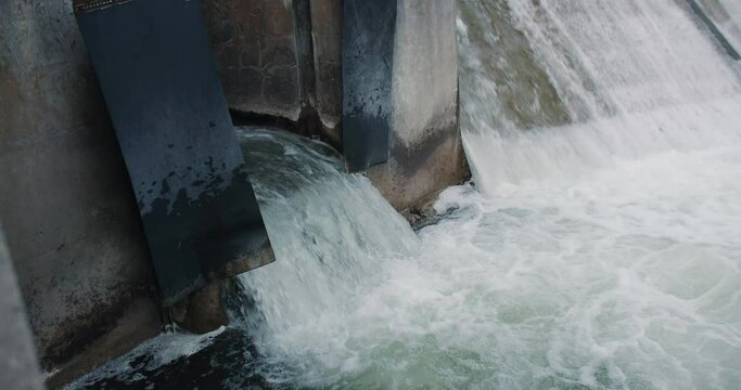 Rushing Water Flowing out of Dam Drainage Overflow Flood Gate. Storm Infrastructure Heavy Rain 4k