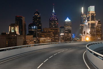Fototapeta na wymiar Empty urban asphalt road exterior with city buildings background. New modern highway concrete construction. Concept way to success. Transportation logistic industry fast delivery. Philadelphia. USA.