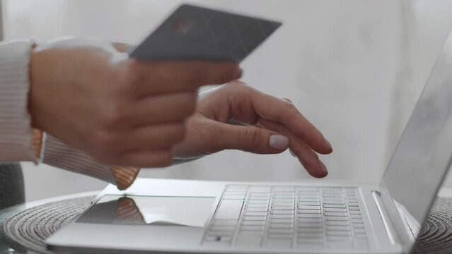Online banking. Unrecognizable woman customer entering credit card data on website, making payment on laptop, free space