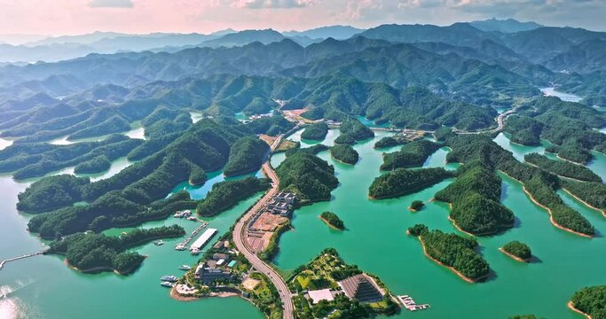 Aerial footage of Thousand Island Lake natural scenery in Hangzhou, Zhejiang Province, China. curving road and mountain natural landscapes in summer.