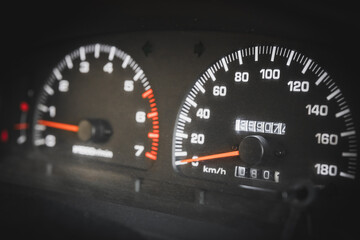 Close-up of a speedometer and tachometer in a used car.