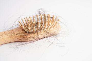Hair loss fall with comb brush isolated on white background.