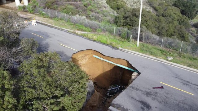 Large Sink hole forms in road