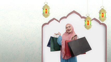 Asian Muslim woman in veil holding shopping bags