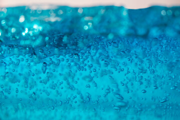 fake wave, selective focus small bubble floating in blue gel like under the ocean.