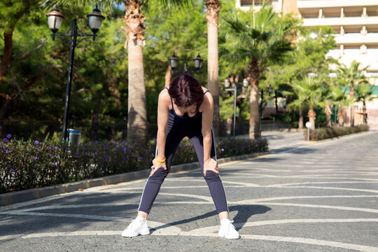 Athlete Stopped While Running Catch Her Breath And Gain Strength.