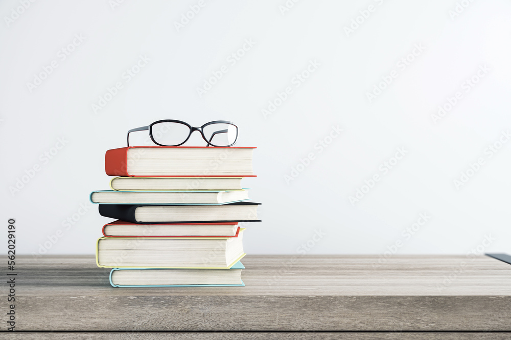 Aufkleber education, personal development and study concept with eyeglasses on stack of books on wooden table 