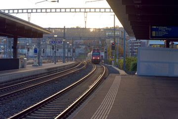 Empty platform with S-Bahn train line S6 destination Baden arriving at railway station Zürich...