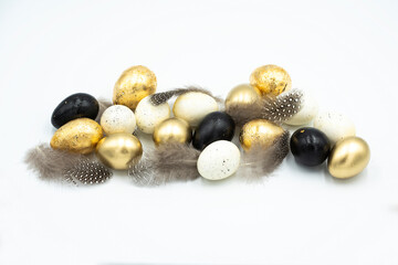 Easter golden and black eggs, feather.