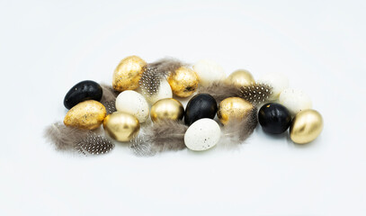 Easter golden and black eggs, feather.
