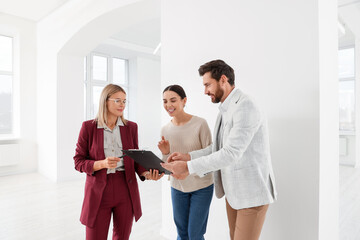 Real estate agent showing new apartment to couple
