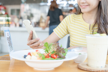 Woman use smartphone to scan QR code to pay in cafe restaurant with a digital payment without cash. Choose menu and order accumulate discount. E wallet, technology, pay online, credit card, bank app.