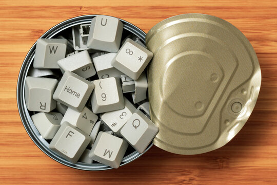 Opened tin can full of computer keyboard keys