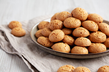 Homemade Italian Amaretti Cookie Biscuits on a Plate, side view. Close-up.