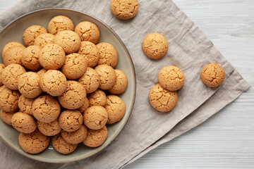 Homemade Italian Amaretti Cookie Biscuits on a Plate, top view. From above, overhead, flat lay.