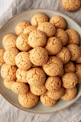 Homemade Italian Amaretti Cookie Biscuits on a Plate, top view. From above, overhead, flat lay. Close-up.