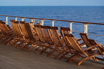 Teak Deck chairs and sun loungers on outdoor balcony terrace patio deck of luxury on legendary...