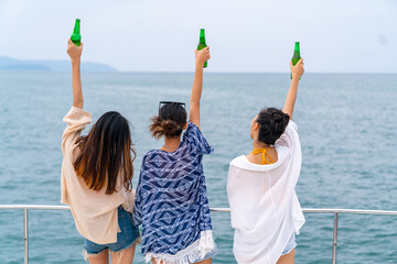 Group of Asian woman friend enjoy and fun outdoor lifestyle celebrating holiday party drinking beer...