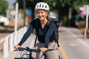 Asian woman bikes to work In good weather