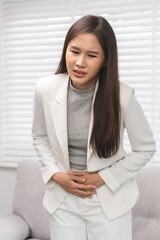 Flatulence, abdomen asian young business woman, female hand in stomach ache, expression face suffer from food poisoning, abdominal pain and colon problem, gastritis or diarrhoea, inflammation.