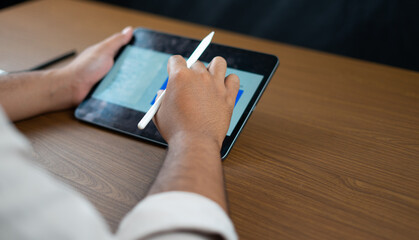 Hands holding pens and tablets for writing business plans
