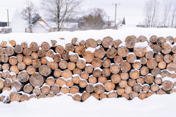Snow piled up on many logs in cold winter