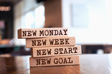 Wooden blocks with words 'New Monday, New week, new start, new goal'.