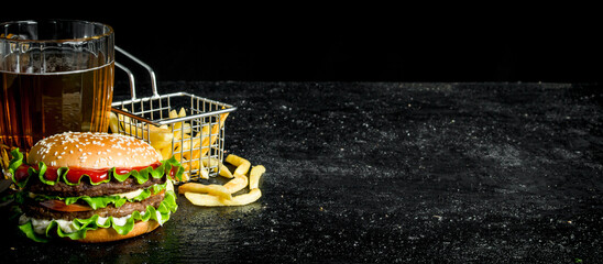 Burger with fries and beer.