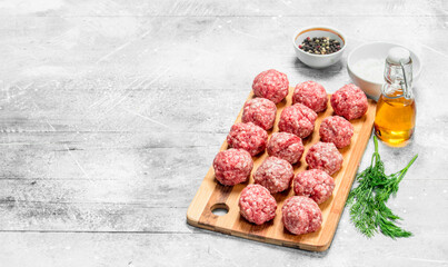 Raw beef meatballs with spices and fragrant dill .